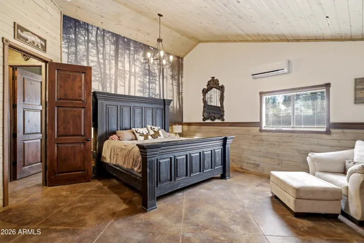 Comfortable bedroom with natural light and warm wood accents.