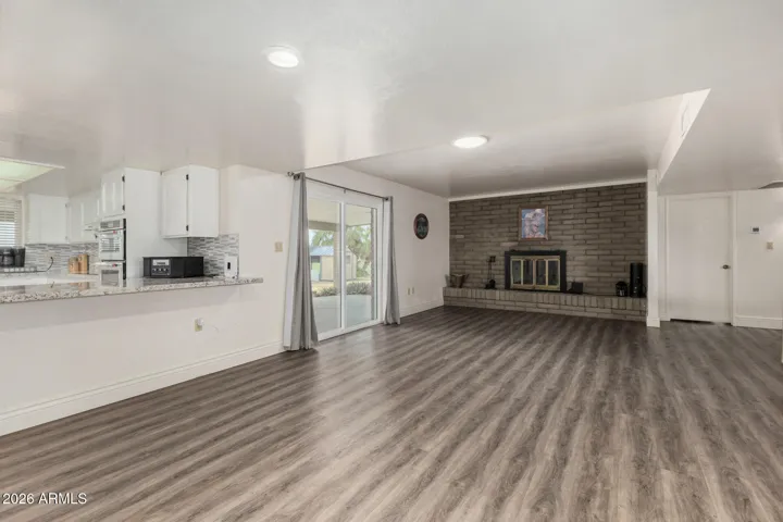 Another view of Dining/Living Room and Kitchen bar with beautiful vinyl flooring