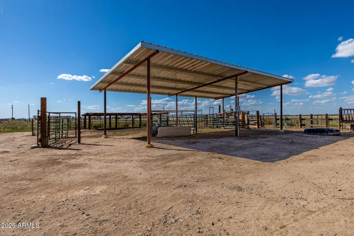 Shade and livestock pens behind shop with chute, water and electric