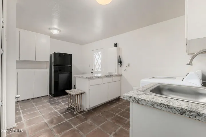 Another view of laundry room with door to backyard
