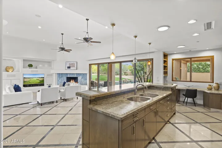 KITCHEN LOOKING OUT TOWARD POOL OASIS AND OFFICE AREA