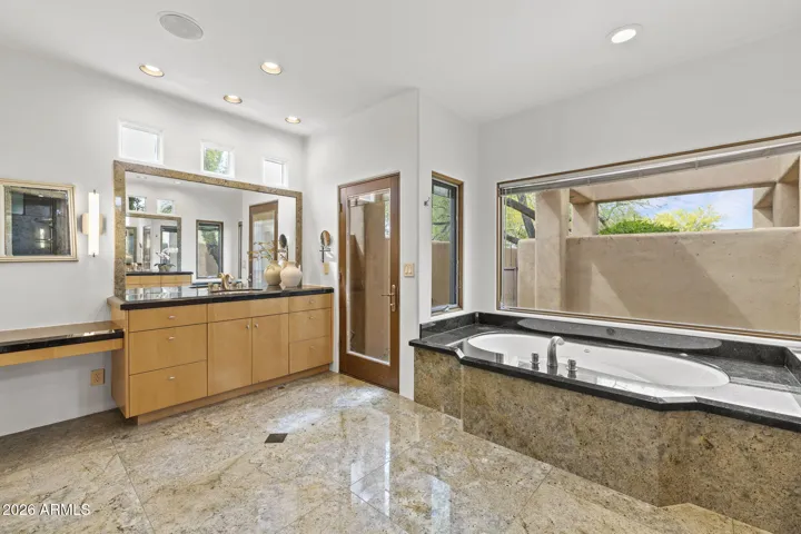 2 SINKS AND VANITY AREA IN PRIMARY BATH WITH PRIVATE PATIO