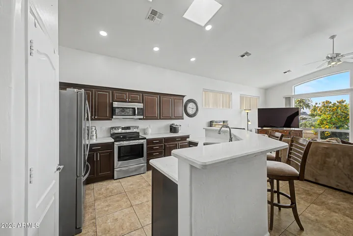 Recently upgraded kitchen features rich cabinetry, quartz counters, drawers and roll-out shelves.