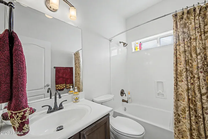 Hall guest bath has natural light and convenience for guests.