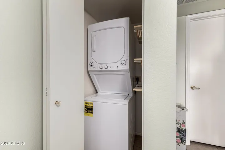 Newer Washing and Dryer Stackable In Hallway
