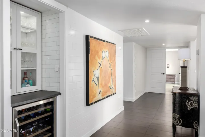 Hall view towards secondary and primary bedrooms. Wine chiller .