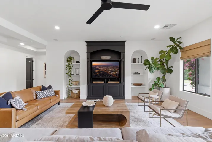 Built-in TV niche and arched shelves in family room