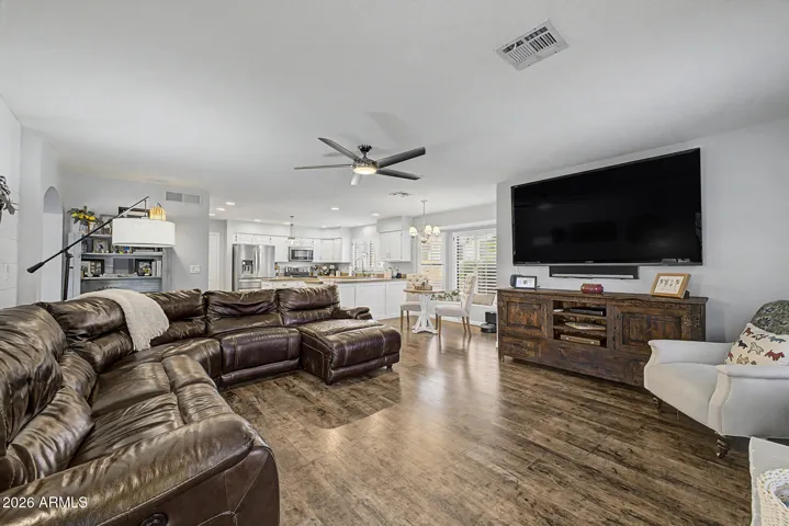 Expansive open-concept layout connecting the living room, dining space, and upgraded kitchen. Features include modern finishes, recessed lighting, and seamless flow for entertaining.