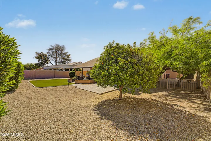 Spacious backyard with mature fruit trees, low-maintenance desert landscaping, and plenty of room to relax or entertain. This Peoria home offers a outdoor retreat.private