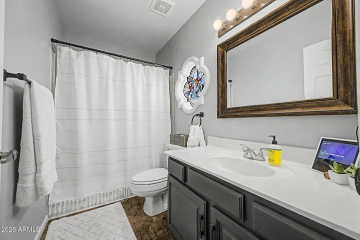 Clean, updated bathroom with modern vanity, framed mirror, and full tub/shower combo. This Peoria home features well-maintained spaces with functional design and contemporary touches.