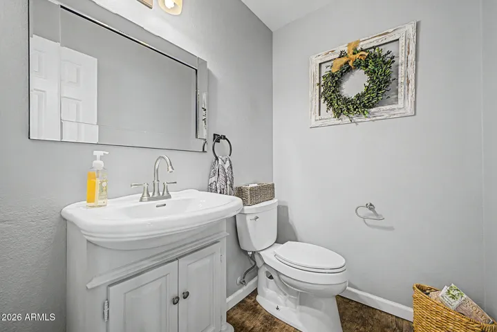 Clean and updated powder room with modern vanity, neutral tones, and stylish finishes. This well-maintained space adds convenience and functionality to this Peoria home.