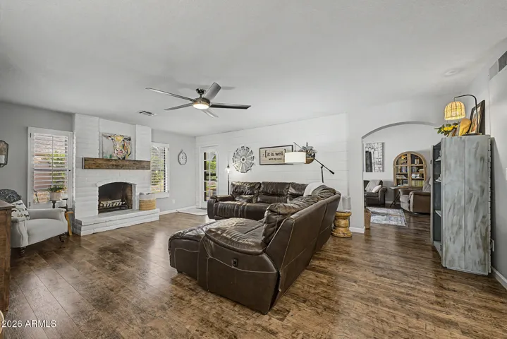 Cozy family room anchored by a beautiful refinished fireplace and accent wall. This open-concept space offers warmth, style, and flow into the main living areas.