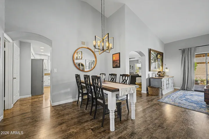Elegant dining area with high ceilings, designer lighting, and open sightlines. Perfect for hosting gatherings, this space complements the home's airy and modern layout.