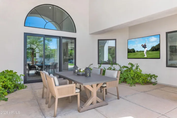Covered Patio with Great Room and Living Room Access
Step outside from the great room and the covered patio welcomes you immediately — a natural extension of the home's living space, shaded and inviting regardless of the season. The outdoor television and comfortable seating make this as functional as any interior room.