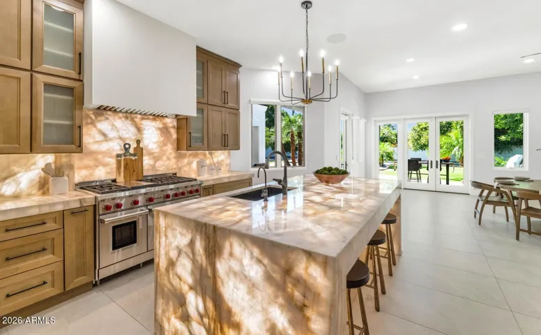 The island is the natural gathering point of this home — wide enough for serious meal prep, comfortable enough for guests to pull up a stool and stay awhile. A single-basin island sink keeps the workspace clean and functional, while the Cristallo stone surface adds an unmistakable touch of elegance.