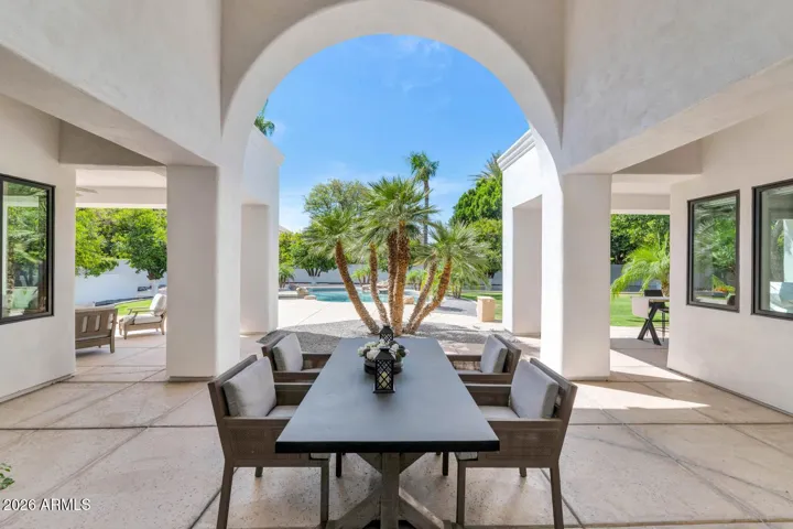 Outdoor Dining
The second covered patio, accessible directly from the great room's dining and fireplace areas, offers a shaded outdoor dining destination perfectly positioned for entertaining. Arched columns, open sightlines to the pool, and a seamless indoor-outdoor connection define this space.
