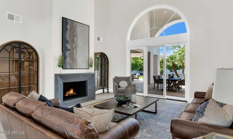 Additional Seating Area
A generous secondary seating area within the main living space offers flexibility for everyday living and gracious entertaining alike. Rich layered textures, warm wood tones, and a second fireplace create a sense of depth and comfort — while views beyond connect the interior seamlessly to the Arizona lifestyle waiting just outside.