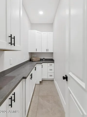 A generous butler's pantry extends the kitchen's functionality with built-in counters, cabinetry, and the kind of behind-the-scenes prep and storage space that serious entertainers quietly depend on. The details that make a home truly livable are rarely this well considered.