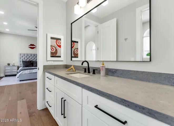 The Jack-and-Jill bathroom shared between two second-floor bedrooms features a crisp white vanity with matte black fixtures and a clean, well-considered layout. Fully renovated and move-in ready, it offers the kind of shared functionality that families actually appreciate.