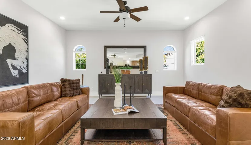 A closer vignette of the family room seating area reveals the quality of the material selections — warm leathers, considered accessories, and a neutral backdrop that allows the furnishings and architecture to speak for themselves.