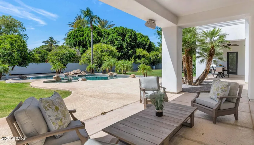 From the primary bedroom's private patio, the pool and spa unfold in an unobstructed view that makes waking up here feel like a daily indulgence. The covered shade, lush surroundings, and stillness of this corner of the property create a sense of retreat that is genuinely rare.