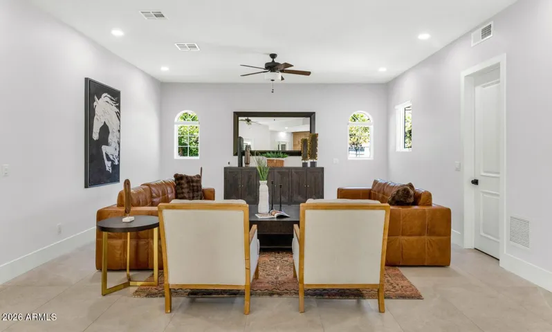 This angle captures the full livability of the family room — comfortable, considered, and connected. Whether the doors are open to the covered patio or the fireplace is the focal point on a winter evening, this space adapts effortlessly to every season and every occasion.