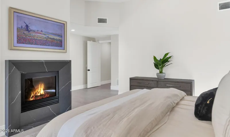 The primary bedroom is a true retreat — anchored by a fireplace and finished with the same warm, intentional palette that flows throughout the home. The entire home, including lighting and climate, is controlled effortlessly from your mobile device, making every morning feel as considered as the design itself.