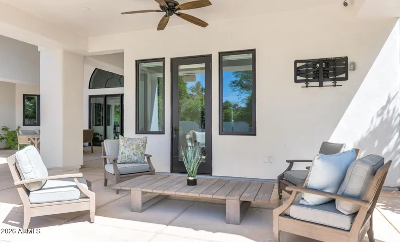The covered patio adjacent to the primary suite offers a private outdoor escape just steps from the bedroom — a quiet morning coffee destination or a serene evening retreat, entirely separate from the main entertaining areas of the home.