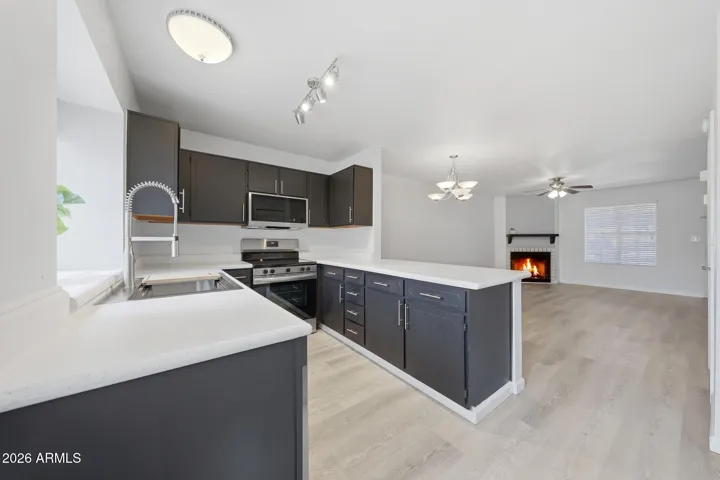 Kitchen with newer stove, microwave and dishwasher