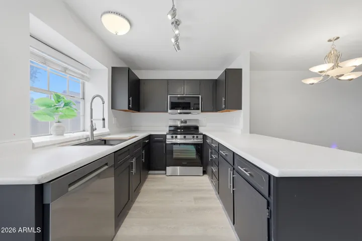 Kitchen with newer stove, microwave and dishwasher