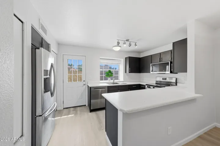 Dining Area & Kitchen with door to patio.