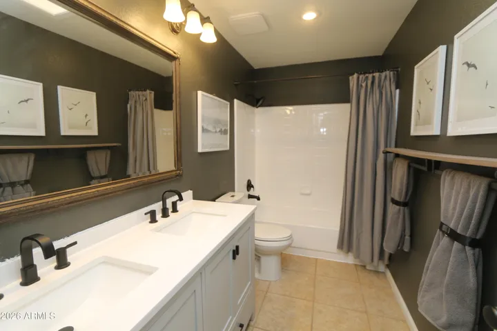Double sinks, tub and shower.