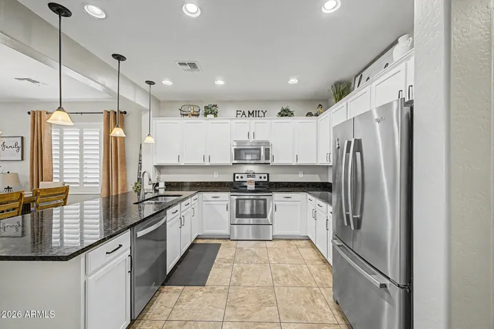 Stainless steel appliances and pendent lighting