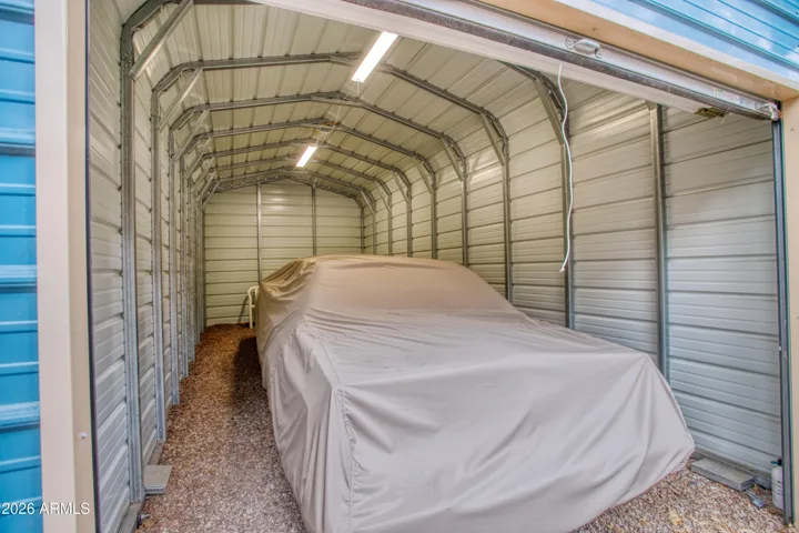metal garage with power, large enough for a vehicle with some room