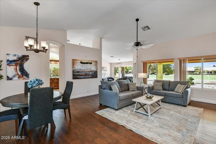 The expansive great room offers a perfect blend of elegance and comfort, with tall ceilings, large windows and wood plank flooring