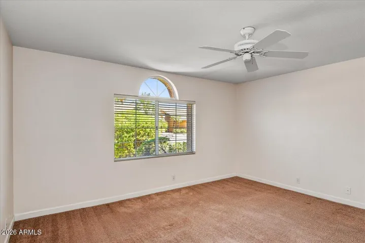 A well-appointed guest room offers ample space for visitors or can easily serve as a comfortable home office.