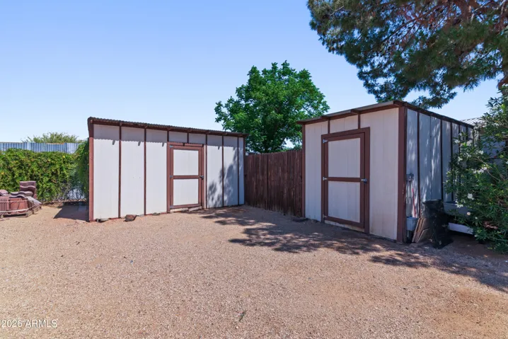 With additional gated storage space in between sheds