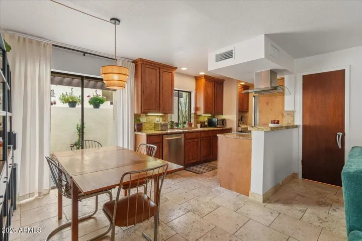 Dining, kitchen & door to downstairs powder room.