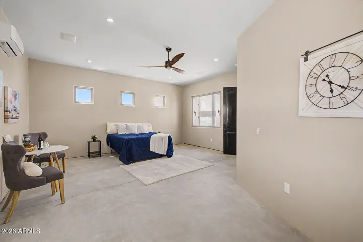 The oversized primary suite is a true retreat, offering generous square footage, mountain views, a sleek designer ceiling fan, and direct access to a spa-inspired ensuite.