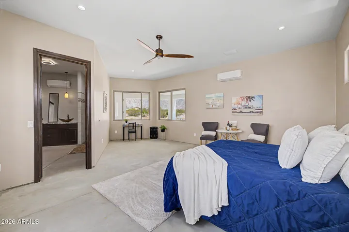 The oversized primary suite is a true retreat, offering generous square footage, mountain views, a sleek designer ceiling fan, and direct access to a spa-inspired ensuite.