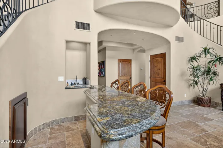 Note the peninsula with seating at the wet bar....