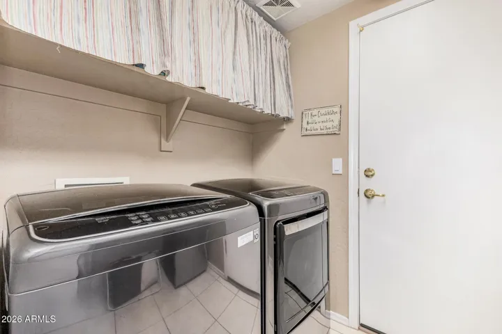 Laundry room with shelving and additional storage space