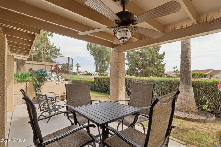 Overlooks golf course with privacy hedge.