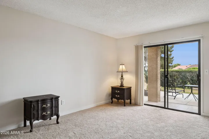 Primary bedroom with patio access.