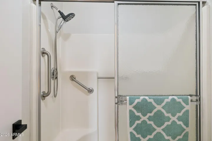 Large shower with grab bars.