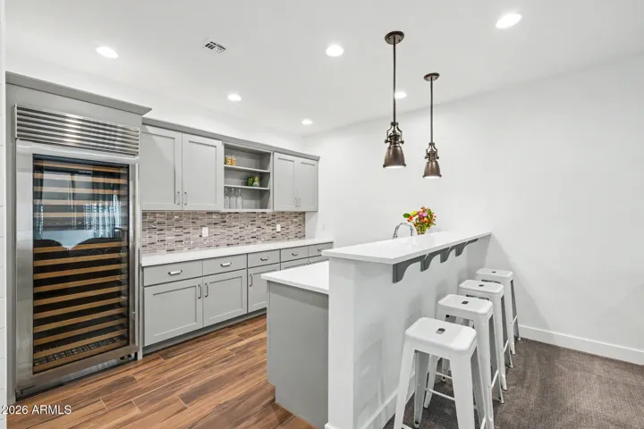 Basement Kitchenette with wine fridge and icemaker