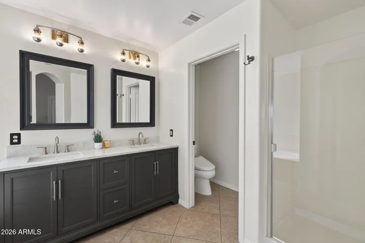 The primary bathroom has a brand new vanity, a new shower door, and a bidet.