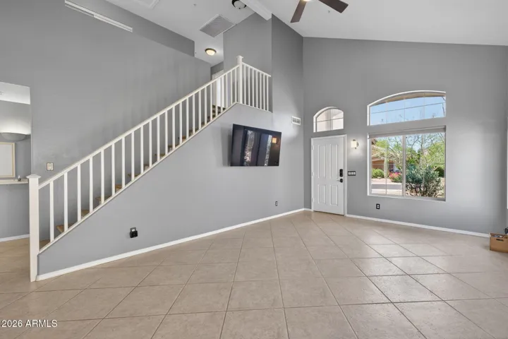 The living room features vaulted ceilings and ample space to relax.