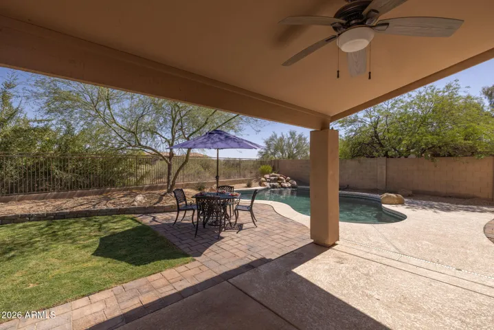 The backyard has a generous amount of covered patio space, to enjoy the outdoors in the shade.