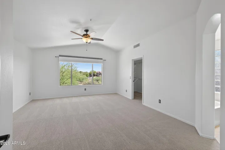 The primary suite is spacious and bright, and features new wall-to-wall carpeting.